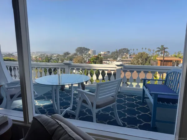 a view of a chairs and table in the balcony