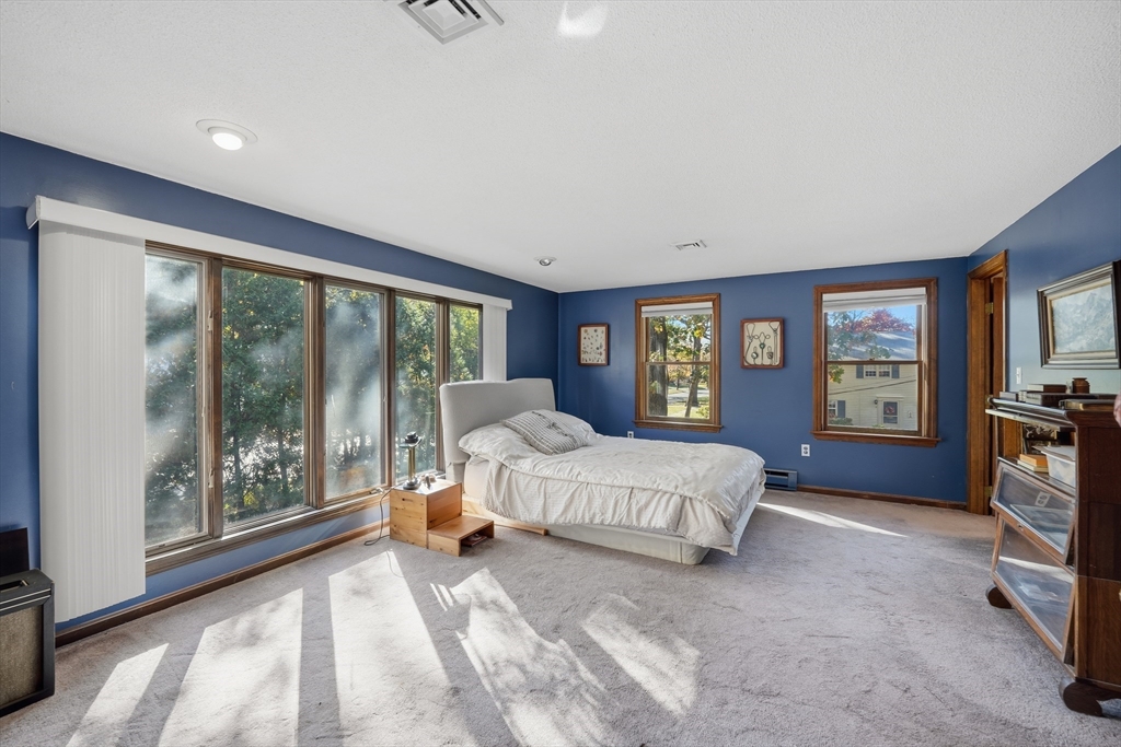 5 Ferncroft Street Longmeadow, MA 01106 - Photo 21 of 40 a spacious bedroom with a bed and large windows