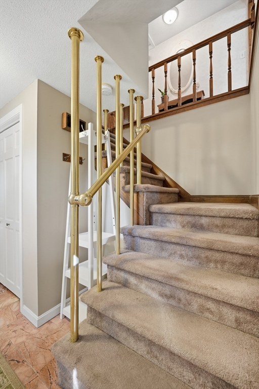 5 Ferncroft Street Longmeadow, MA 01106 - Photo 8 of 40 a view of staircase with lots of frames on wall and a window