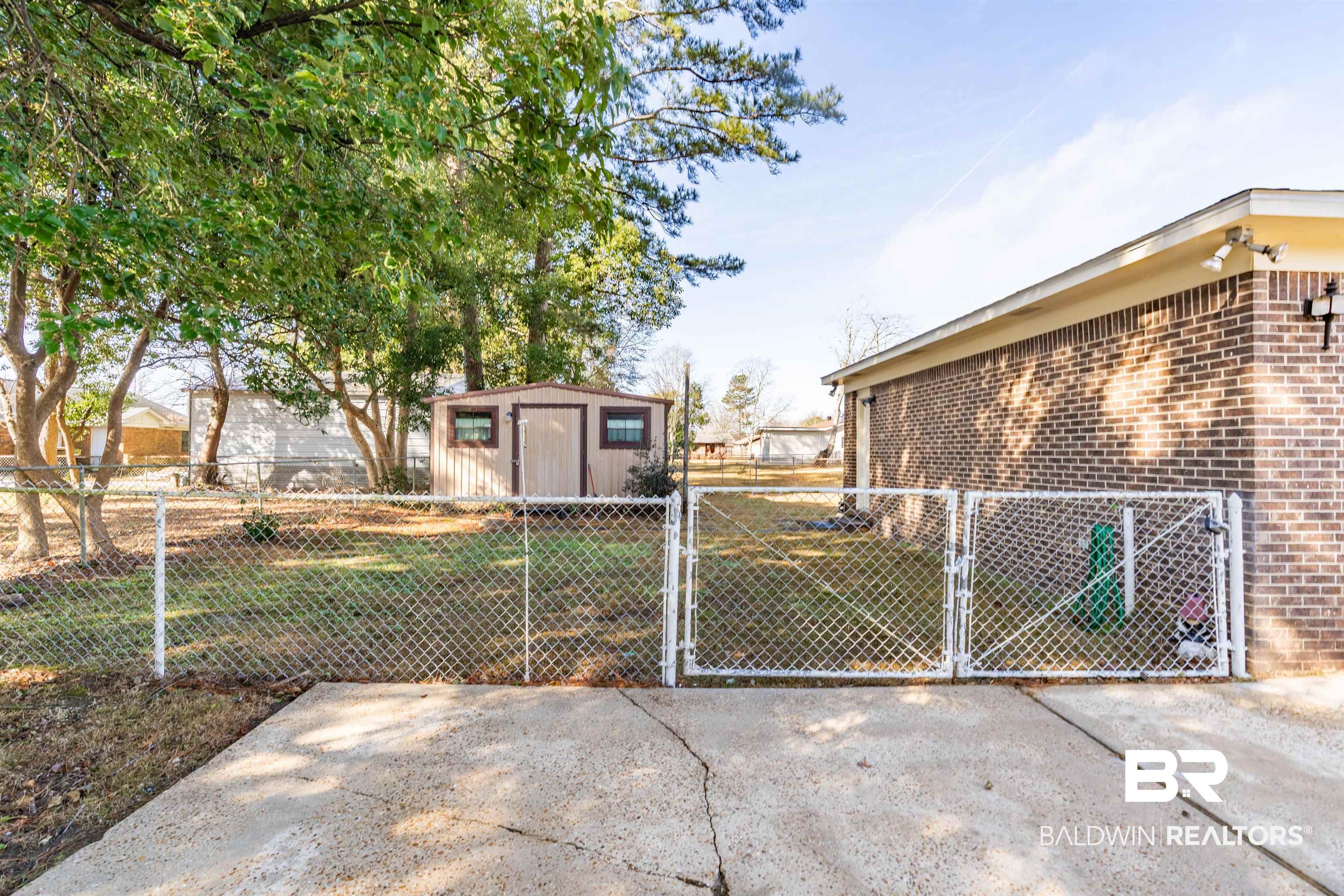 9751 Pine Knoll Road Mobile, AL 36608 - Photo 29 of 36 Exterior space featuring a gate and a shed