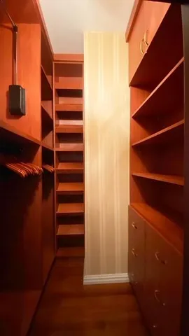 a view of walk in closet with empty racks