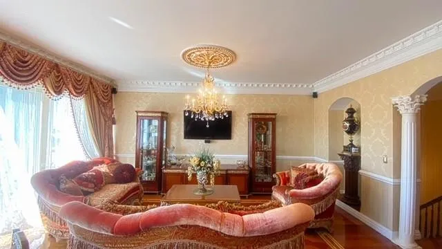 a living room with furniture and a chandelier