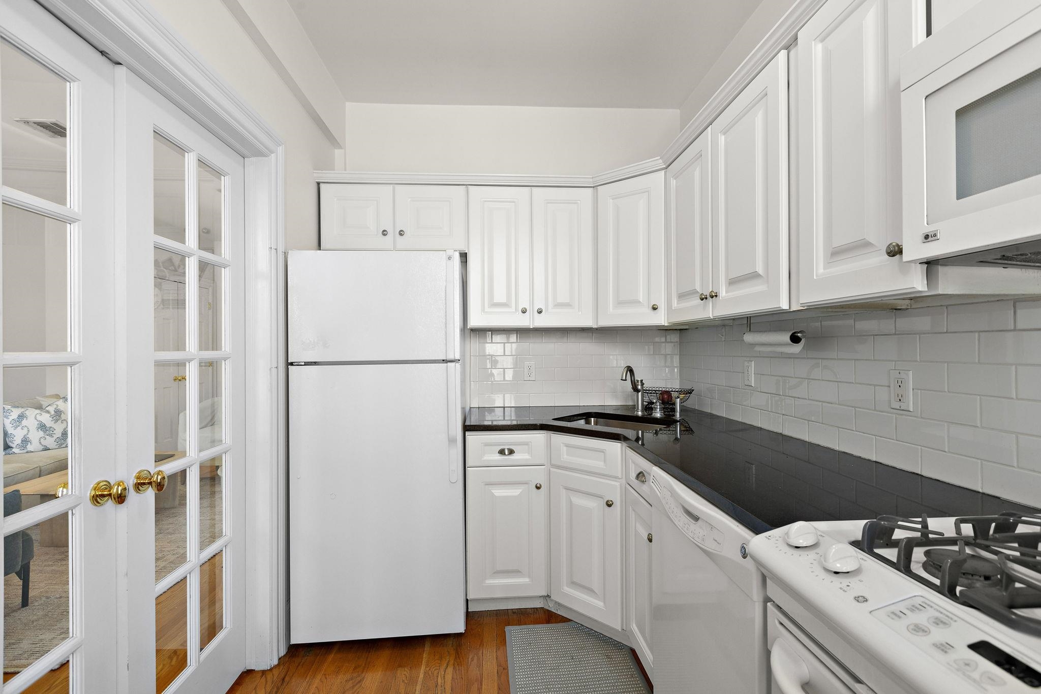 259 4th Street, Unit 2 Hoboken, NJ 07030 - Photo 13 of 20 a kitchen with a white cabinets and white appliances