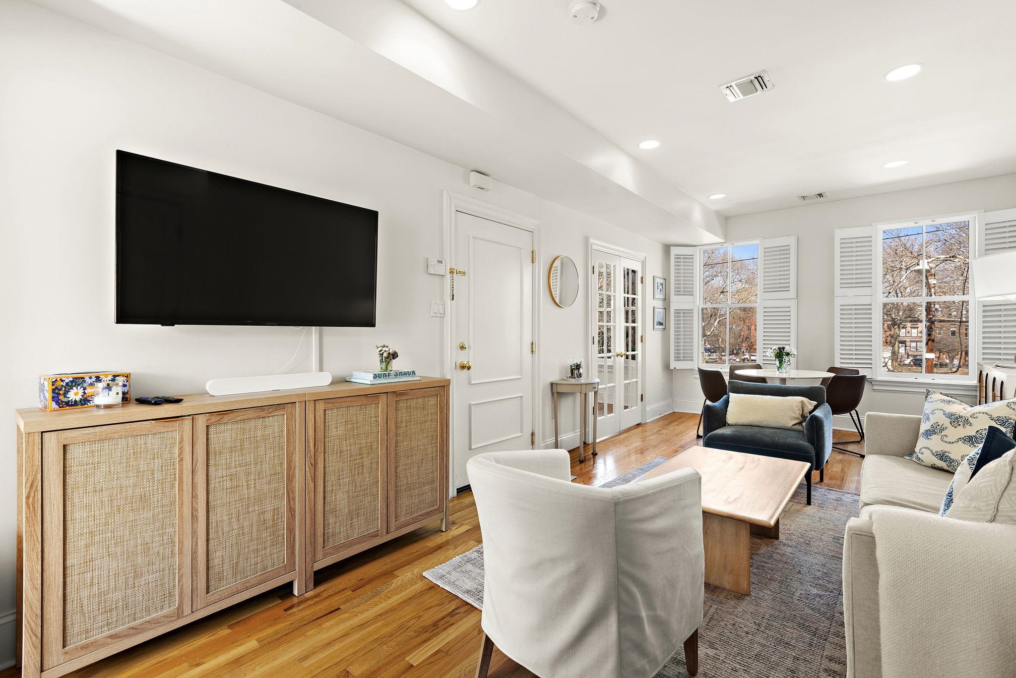 259 4th Street, Unit 2 Hoboken, NJ 07030 - Photo 3 of 20 a living room with furniture a flat screen tv and kitchen view