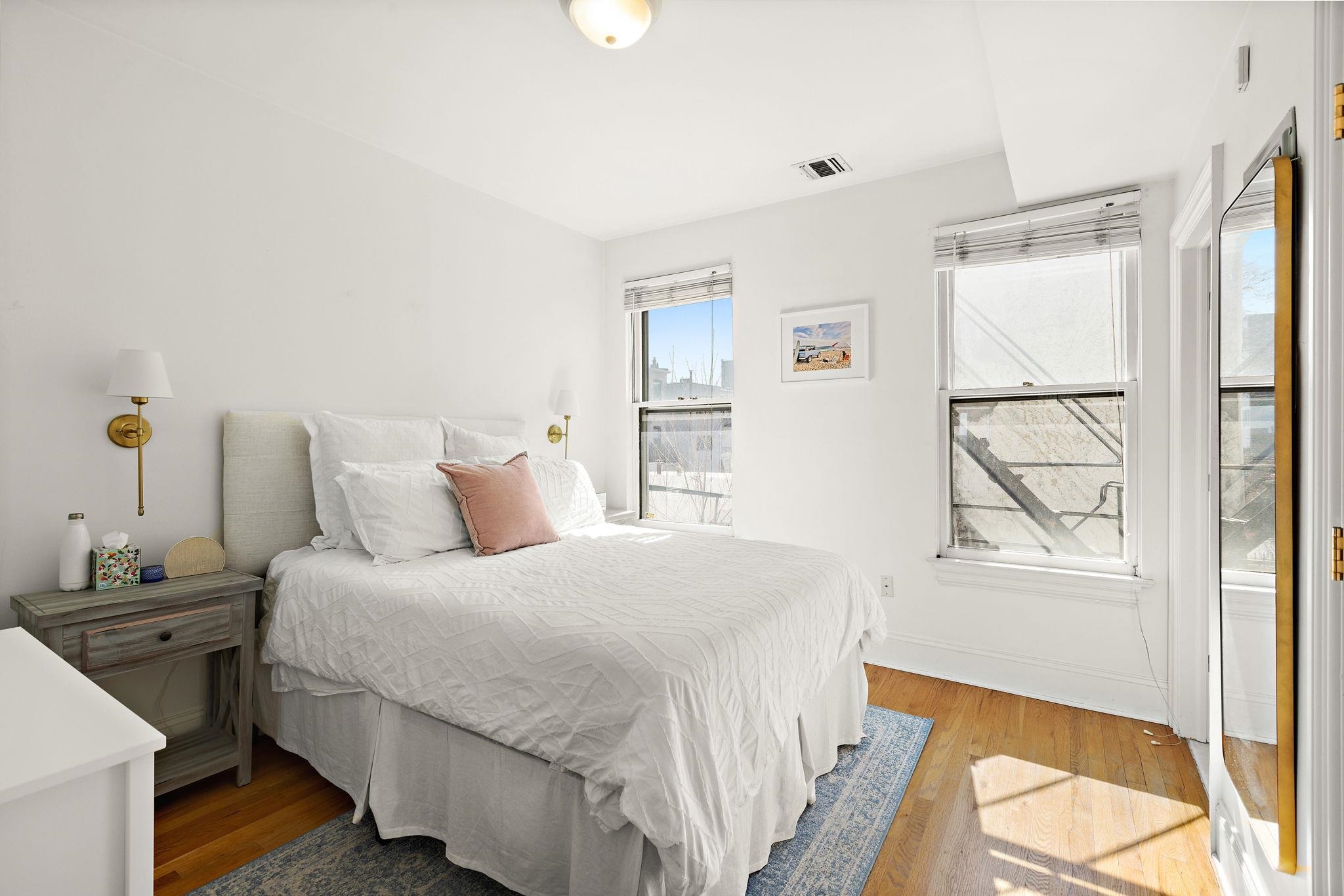 259 4th Street, Unit 2 Hoboken, NJ 07030 - Photo 8 of 20 a bedroom with a bed and a window