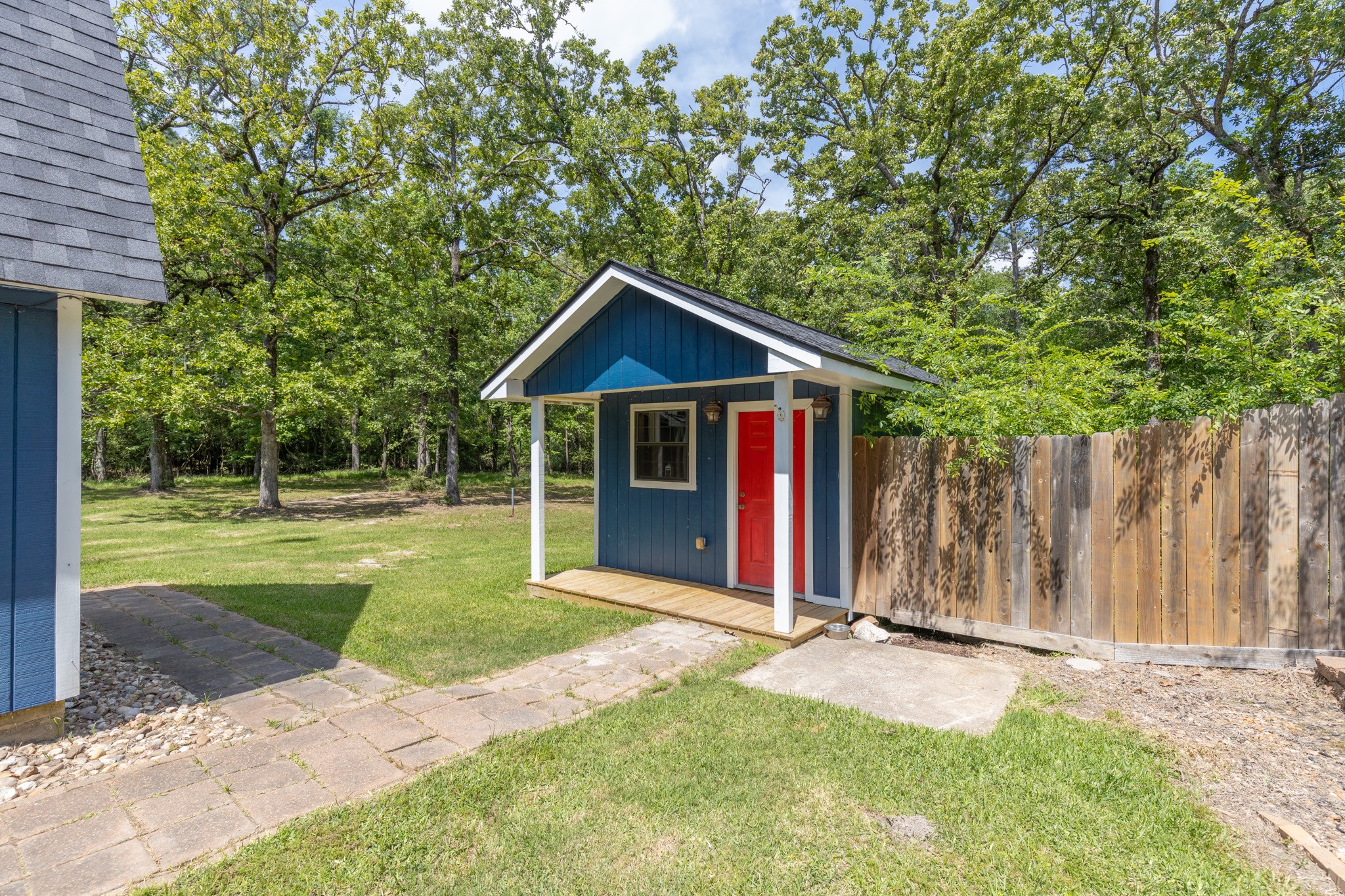 230 Walnut Drive Trinity, TX 75862 - Photo 33 of 48 Adorable storage shed with a quaint front porch—perfect for stashing your mower, gardening tools, and pool supplies, all while adding a touch of charm to your backyard!