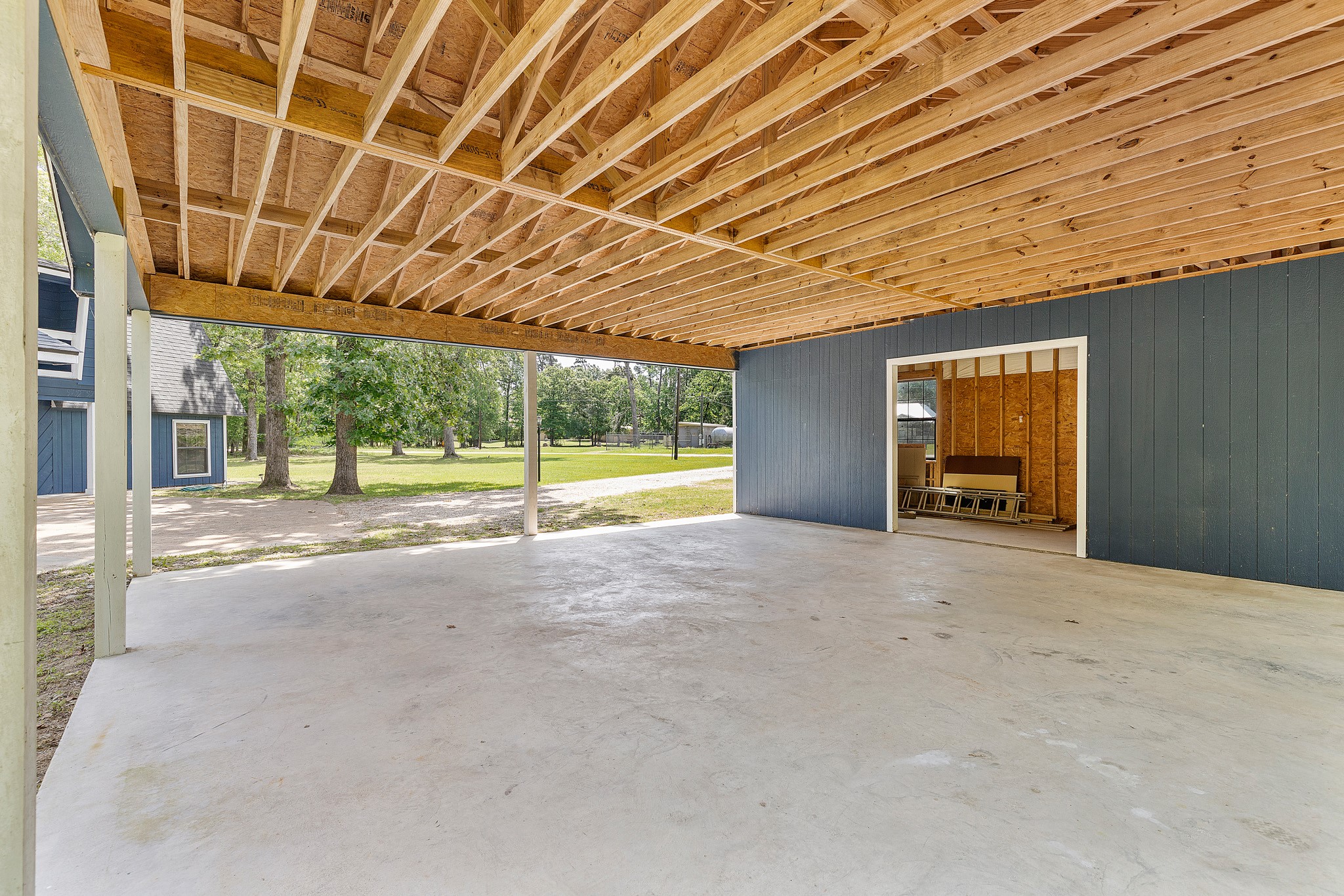 230 Walnut Drive Trinity, TX 75862 - Photo 36 of 48 Spacious 30x36 covered parking area—perfect for your RV or boat—with additional storage space that’s ideal for hosting gatherings or easily enclosed to create the workshop of your dreams.