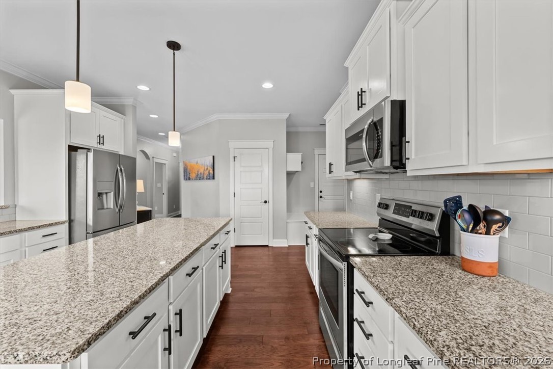 650 Cromwell Court Carthage, NC 28327 - Photo 11 of 39 a kitchen with stainless steel appliances granite countertop a sink a stove and a wooden floors