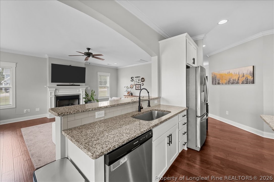 650 Cromwell Court Carthage, NC 28327 - Photo 12 of 39 a kitchen with stainless steel appliances granite countertop a sink and a refrigerator