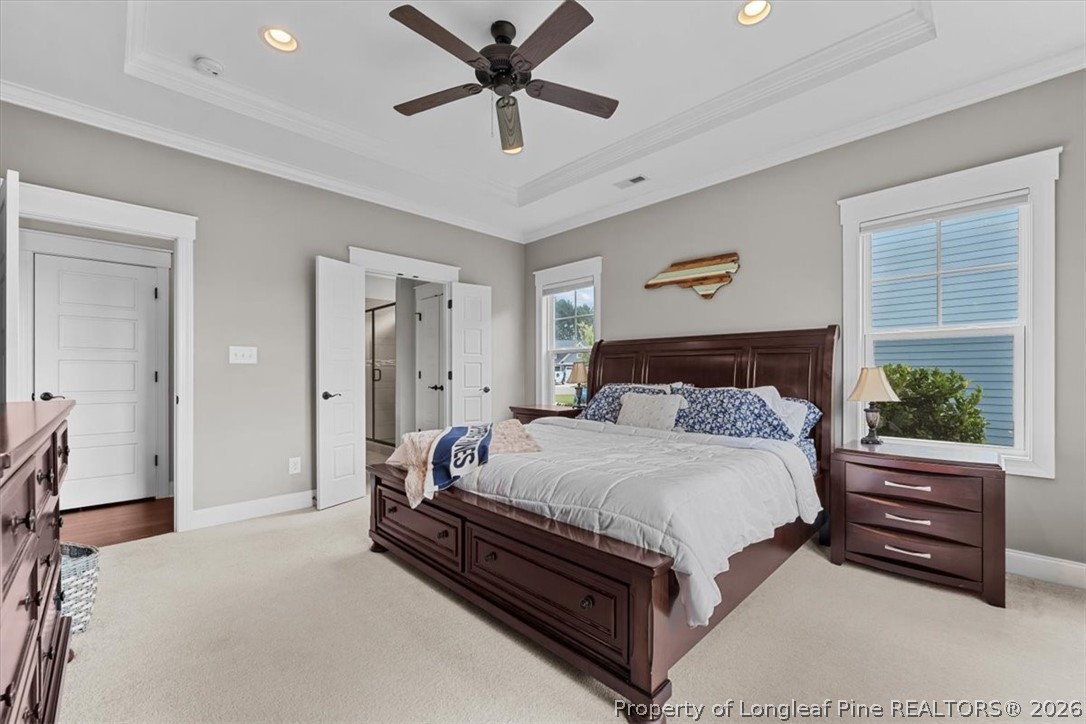 650 Cromwell Court Carthage, NC 28327 - Photo 17 of 39 a bedroom with a bed and a chandelier