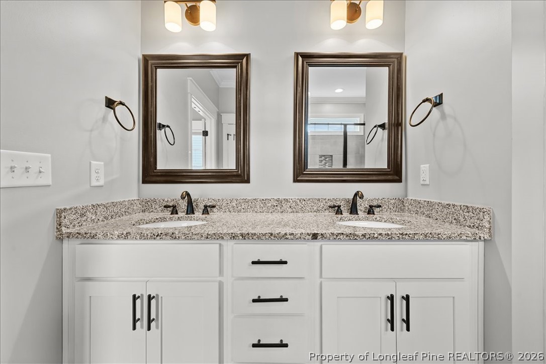 650 Cromwell Court Carthage, NC 28327 - Photo 20 of 39 a bathroom with double sink and a mirror