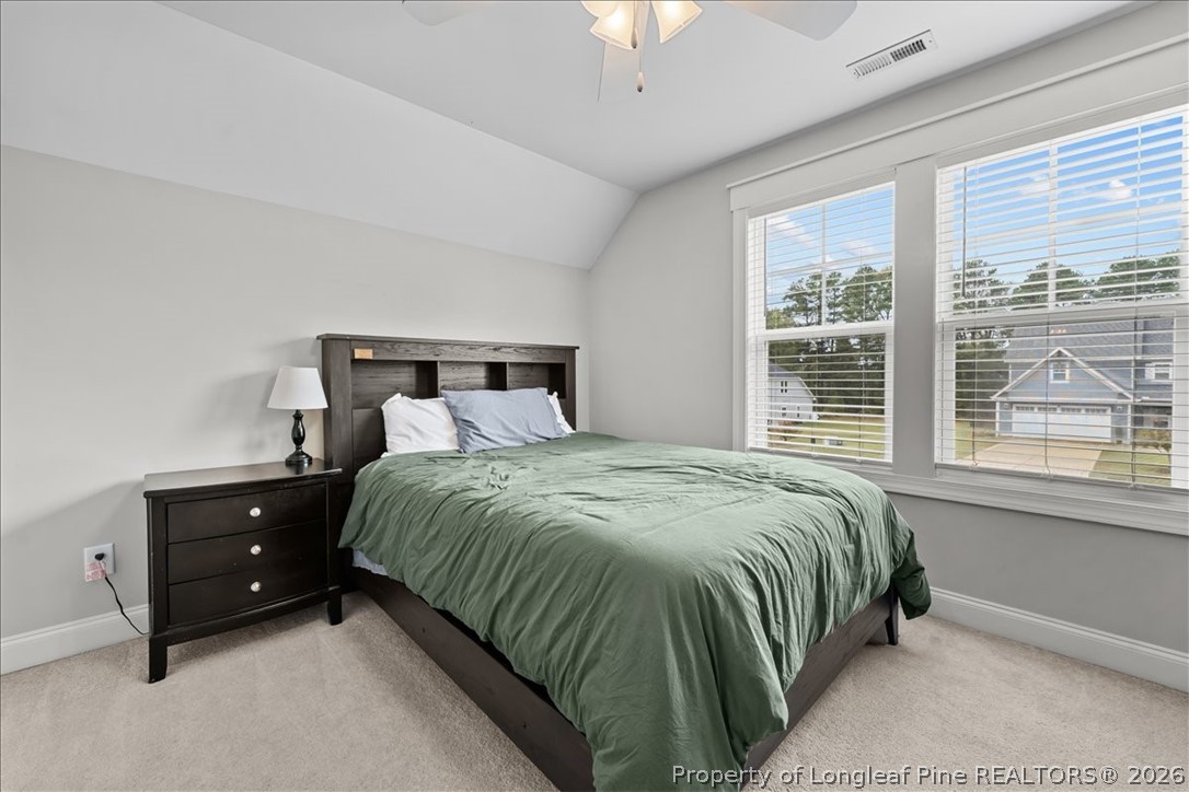 650 Cromwell Court Carthage, NC 28327 - Photo 21 of 39 a bed sitting in a bedroom next to a window