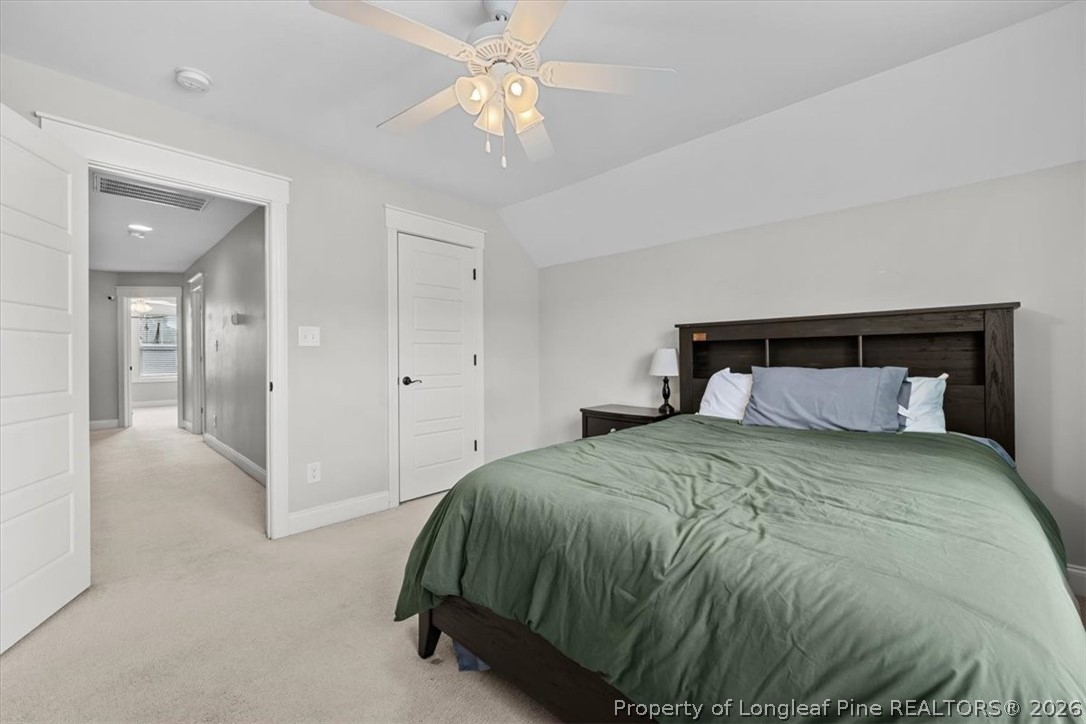 650 Cromwell Court Carthage, NC 28327 - Photo 22 of 39 a bedroom with a bed and a chandelier