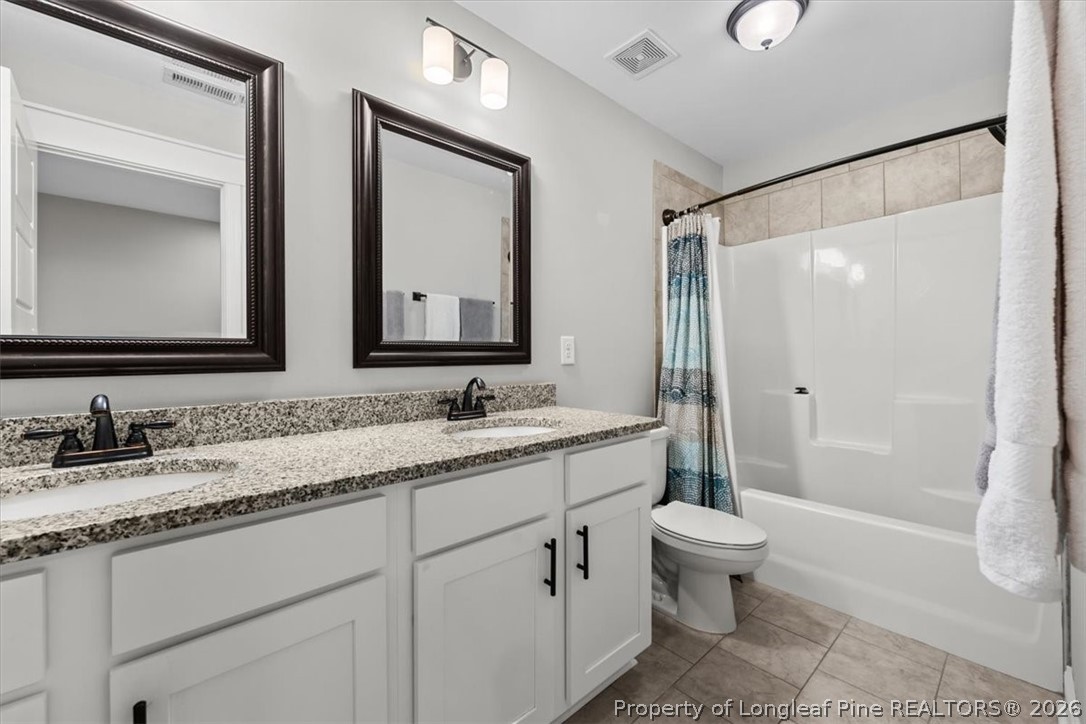 650 Cromwell Court Carthage, NC 28327 - Photo 23 of 39 a bathroom with a granite countertop sink a toilet and a mirror