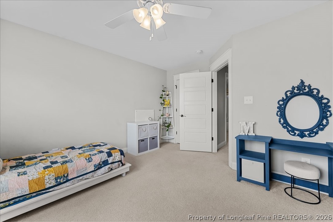 650 Cromwell Court Carthage, NC 28327 - Photo 25 of 39 a bedroom with a bed and a chandelier