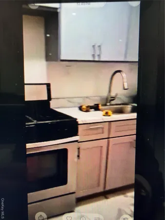a stove top oven sitting inside of a kitchen