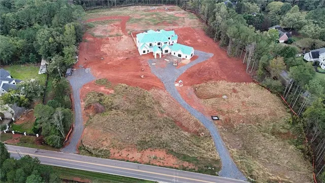 an aerial view of a house with a yard