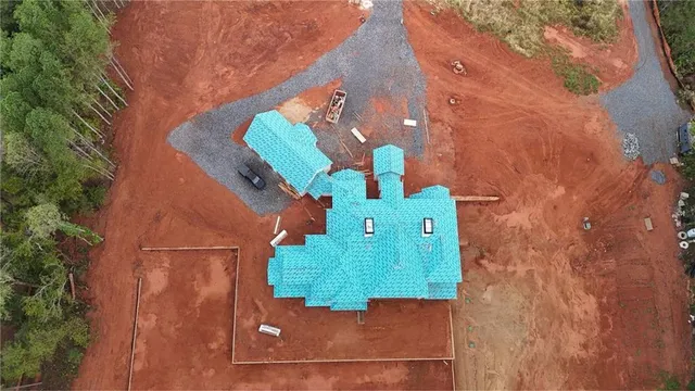 a aerial view of a house with a yard and balcony