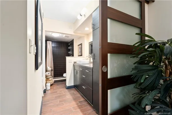 a bathroom with a double vanity sink toilet and shower