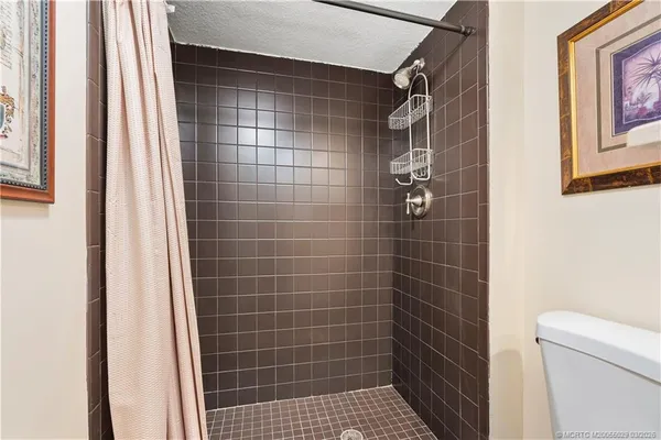 a view of a hallway with wooden floor and a potted plant