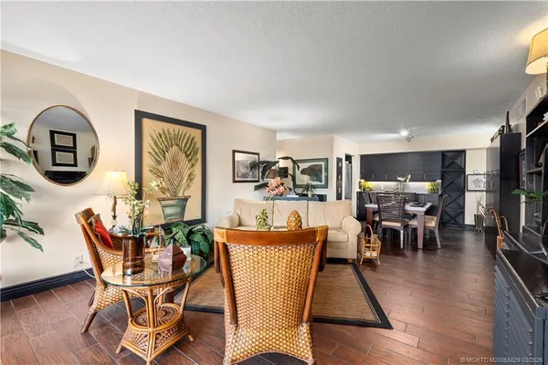 a kitchen with a table chairs and a refrigerator