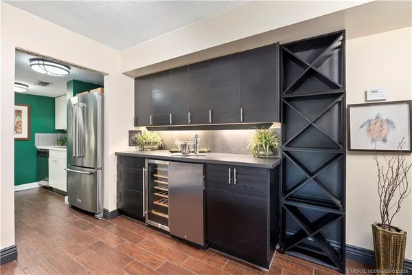 a kitchen with stainless steel appliances double vanity sink and wooden cabinets