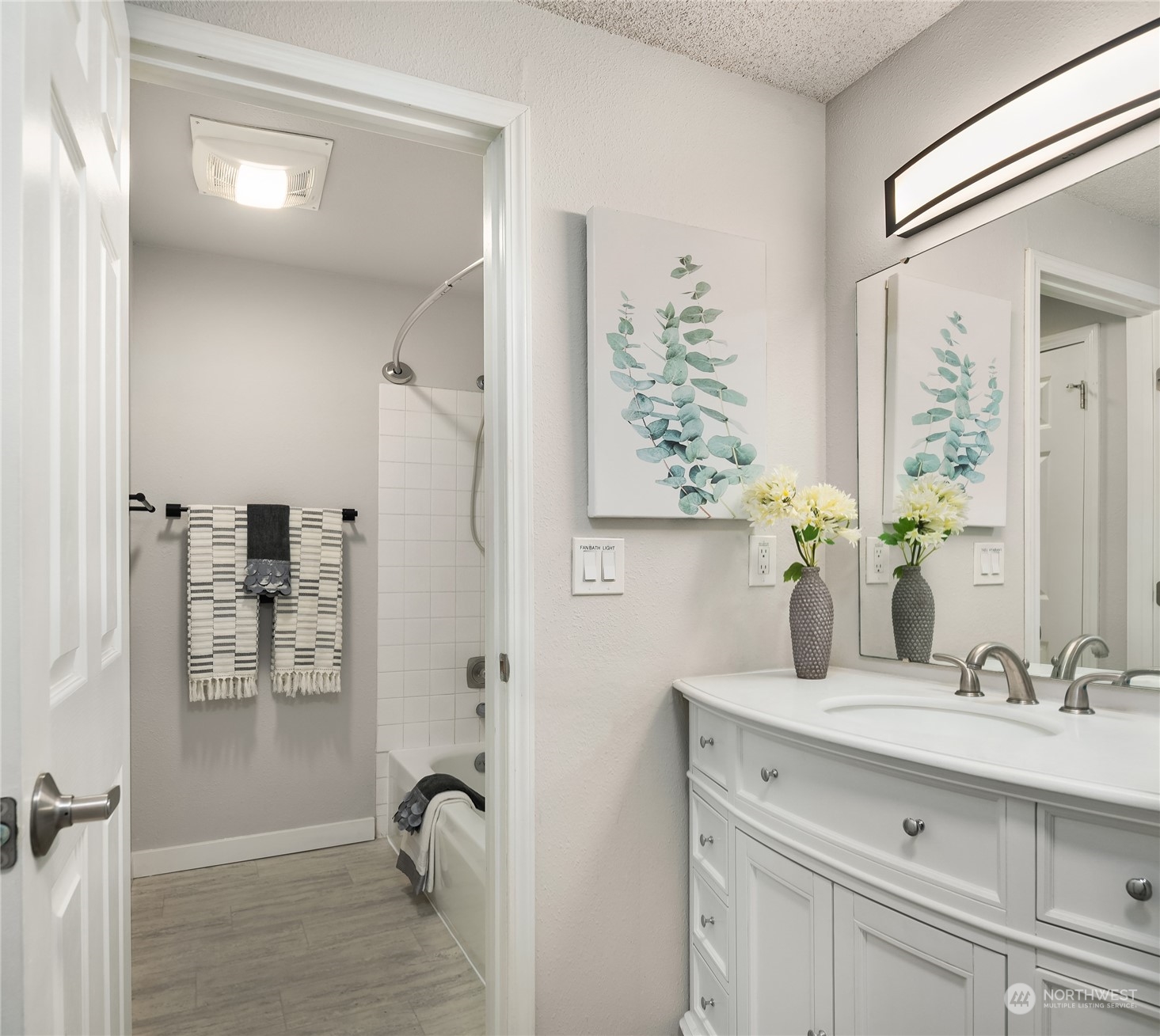 1555 Union Avenue Northeast, Unit 57 Renton, WA 98059 - Photo 22 of 28 a bathroom with a granite countertop sink a mirror and shower