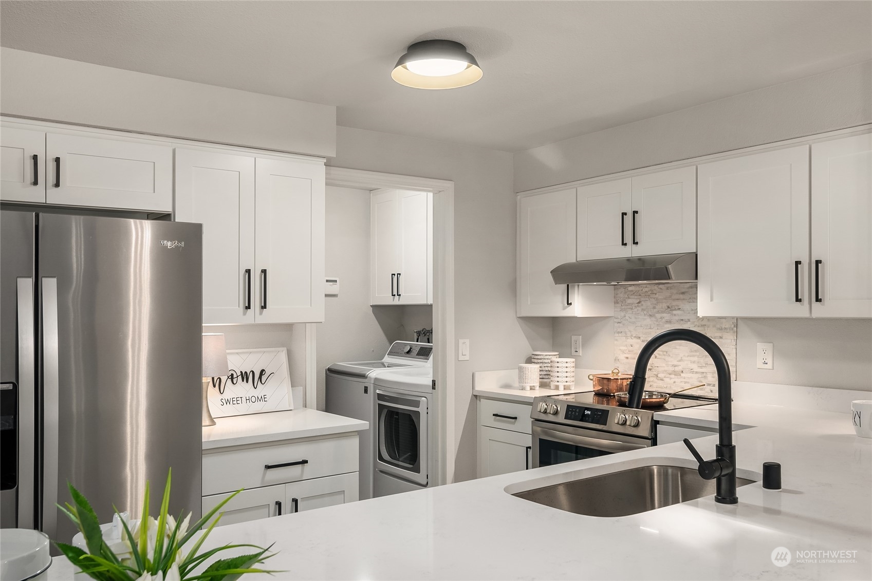 1555 Union Avenue Northeast, Unit 57 Renton, WA 98059 - Photo 7 of 28 a kitchen with stainless steel appliances a refrigerator sink and cabinets