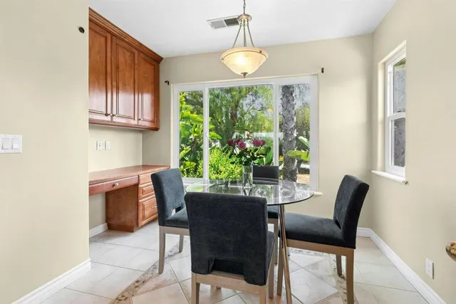 a dining room with furniture and window