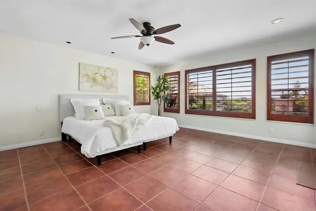 a bedroom with a bed and a large window