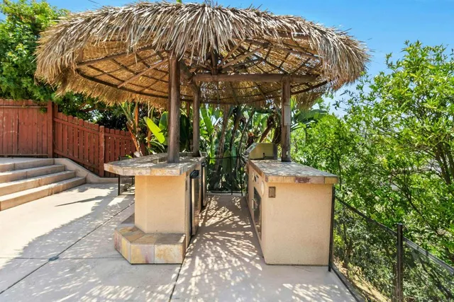 a view of backyard with swimming pool and seating space