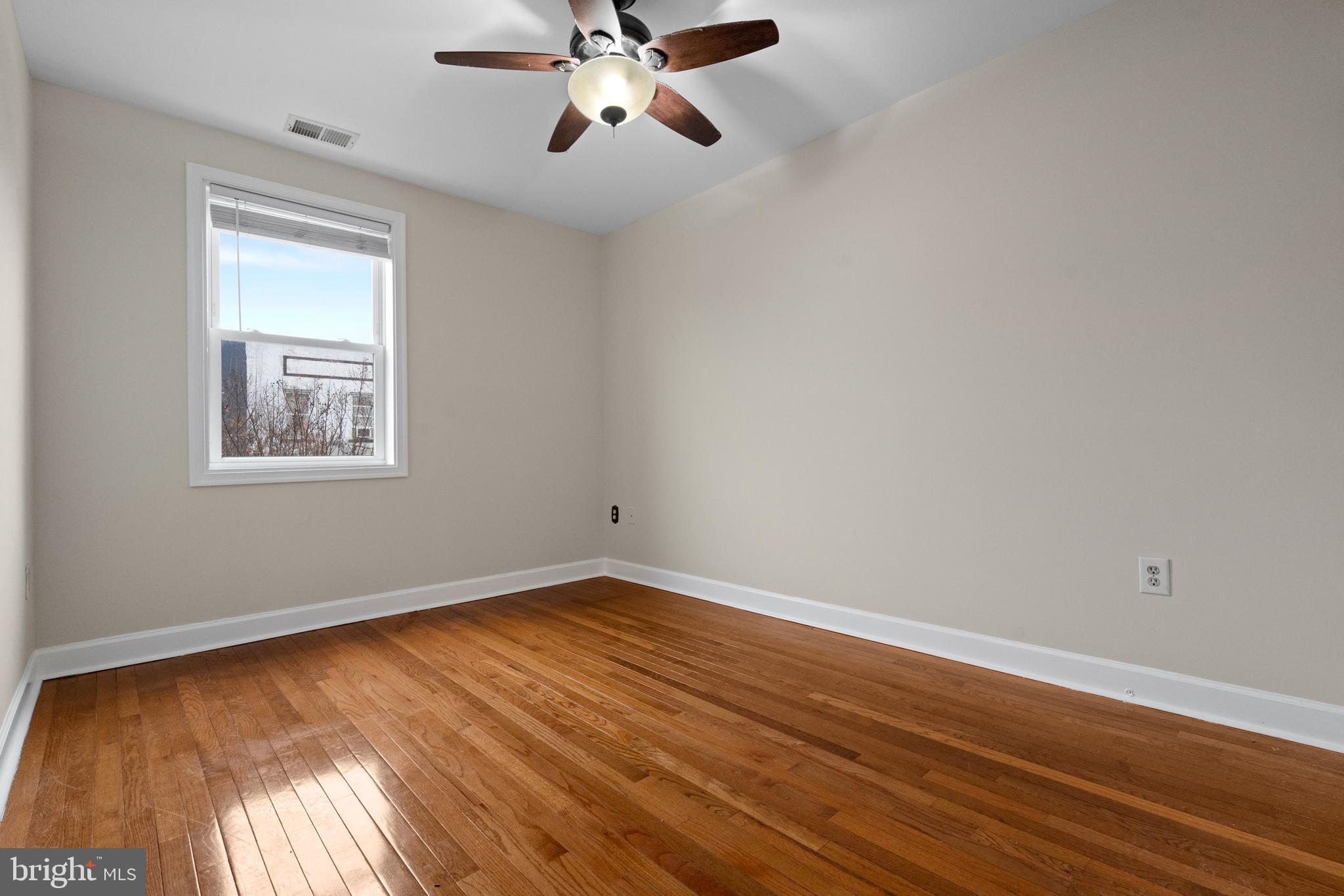 1909 Rosedale Street Northeast, Unit 3 Washington, DC 20002 - Photo 5 of 23 a view of an empty room with wooden floor and a window