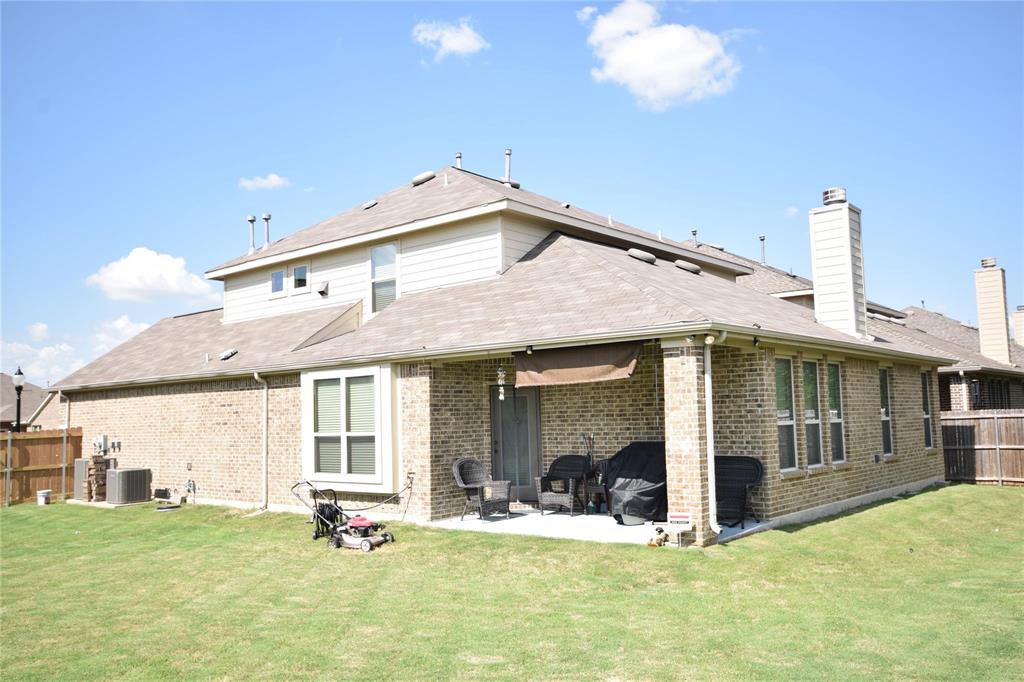12421 Hitch Rack Way McKinney, TX 75071 - Photo 19 of 21 a view of a house with lawn chairs and floor to ceiling window