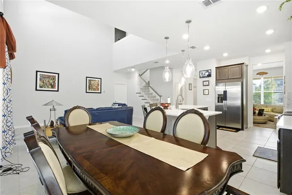 a kitchen with a table chairs and a living room