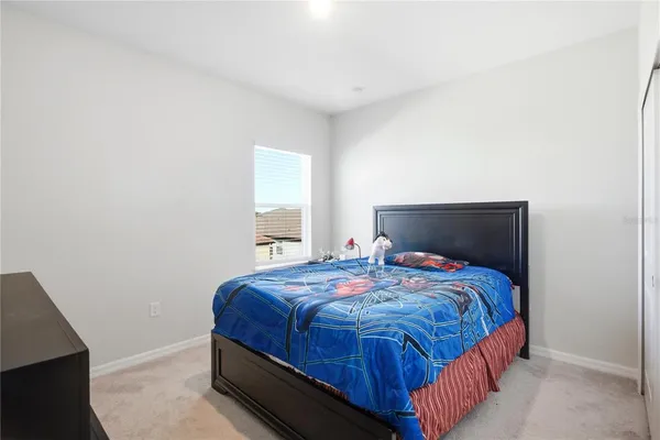 a bedroom with a bed and window