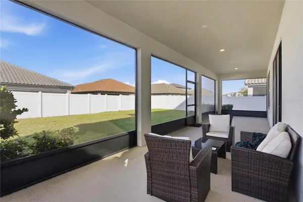 a view of a yard with a large tree in front of it