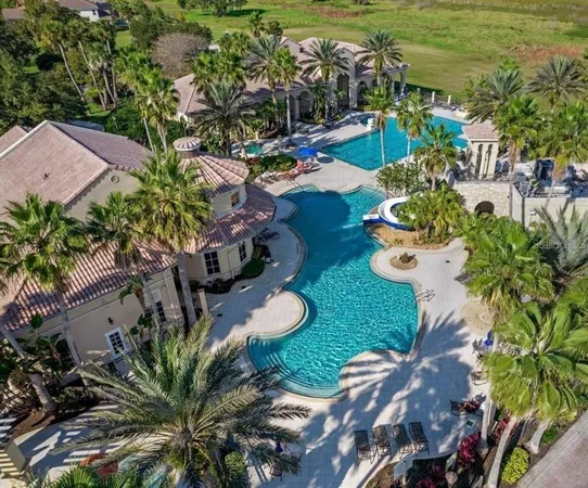an aerial view of a house a yard and outdoor seating
