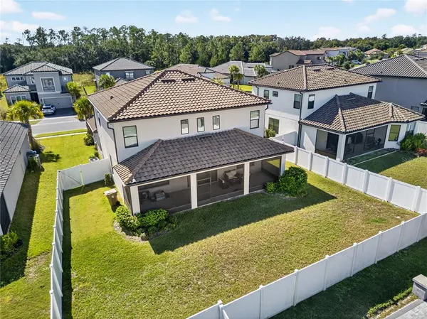 an aerial view of residential houses with yard