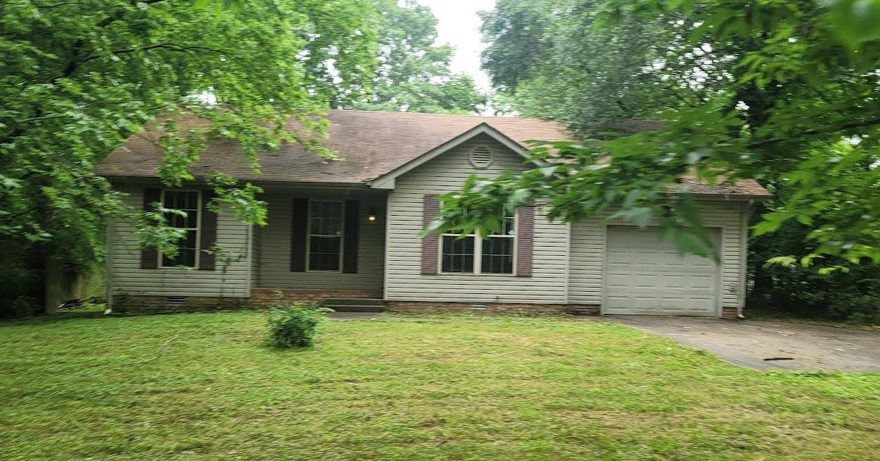 744 Needmore Road Clarksville, TN 37040 - Photo 1 of 12 a front view of a house with a yard