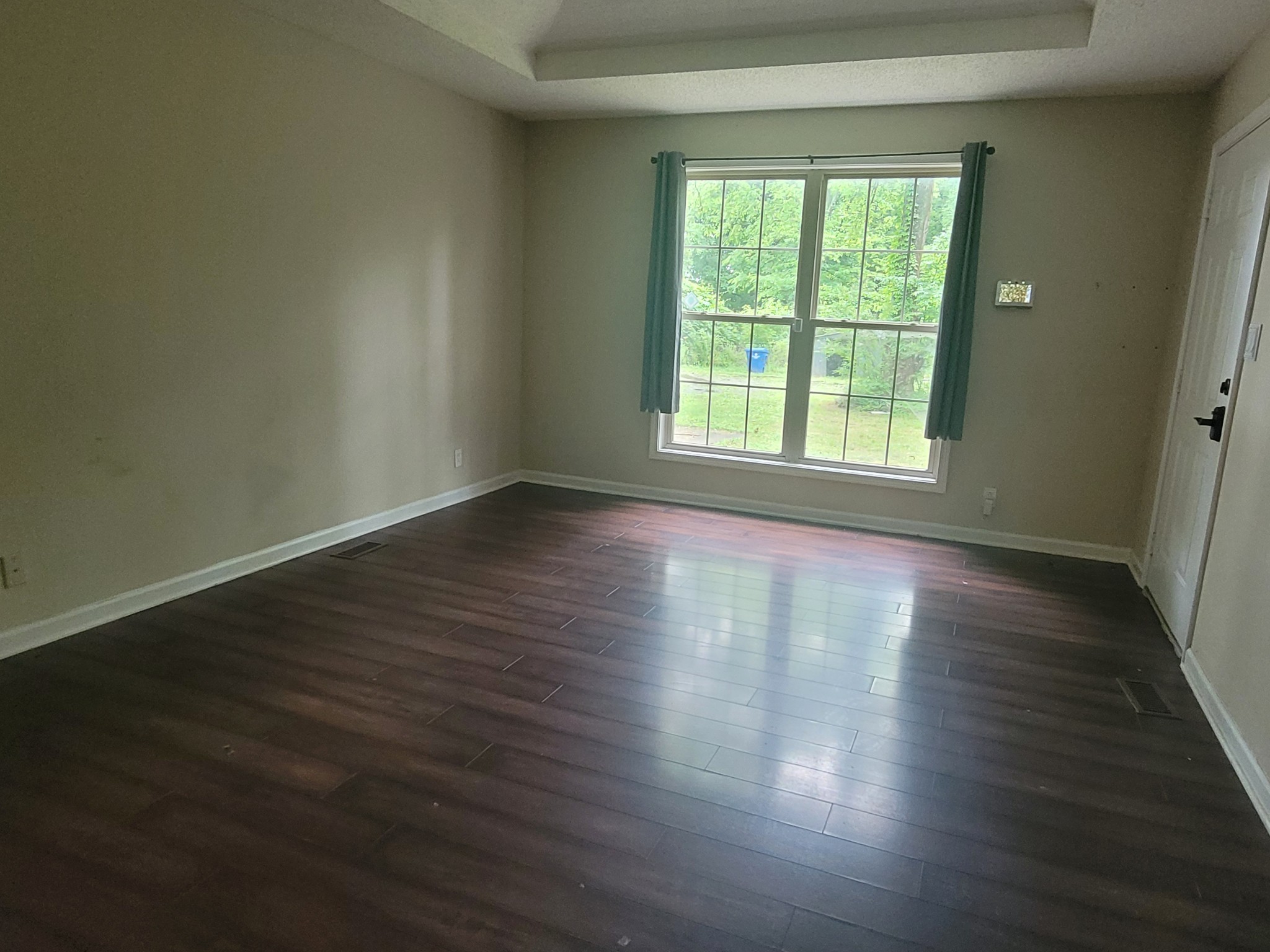744 Needmore Road Clarksville, TN 37040 - Photo 2 of 12 an empty room with wooden floor and windows