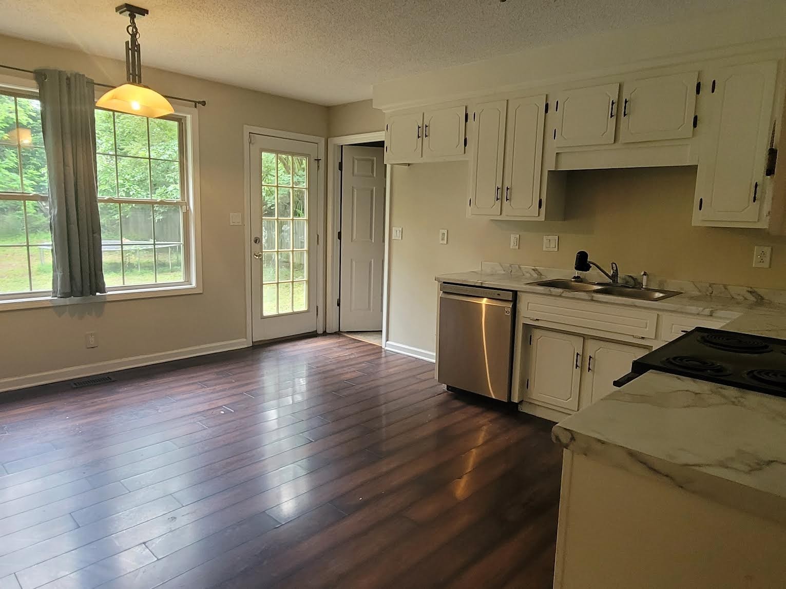 744 Needmore Road Clarksville, TN 37040 - Photo 3 of 12 a kitchen with stainless steel appliances granite countertop a sink a stove a refrigerator and wooden floor