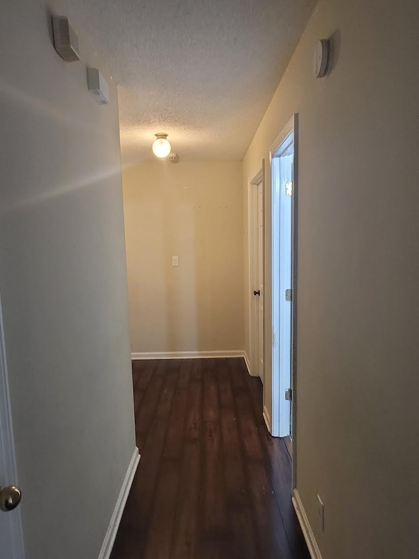 744 Needmore Road Clarksville, TN 37040 - Photo 4 of 12 a view of a room with wooden floor and white walls