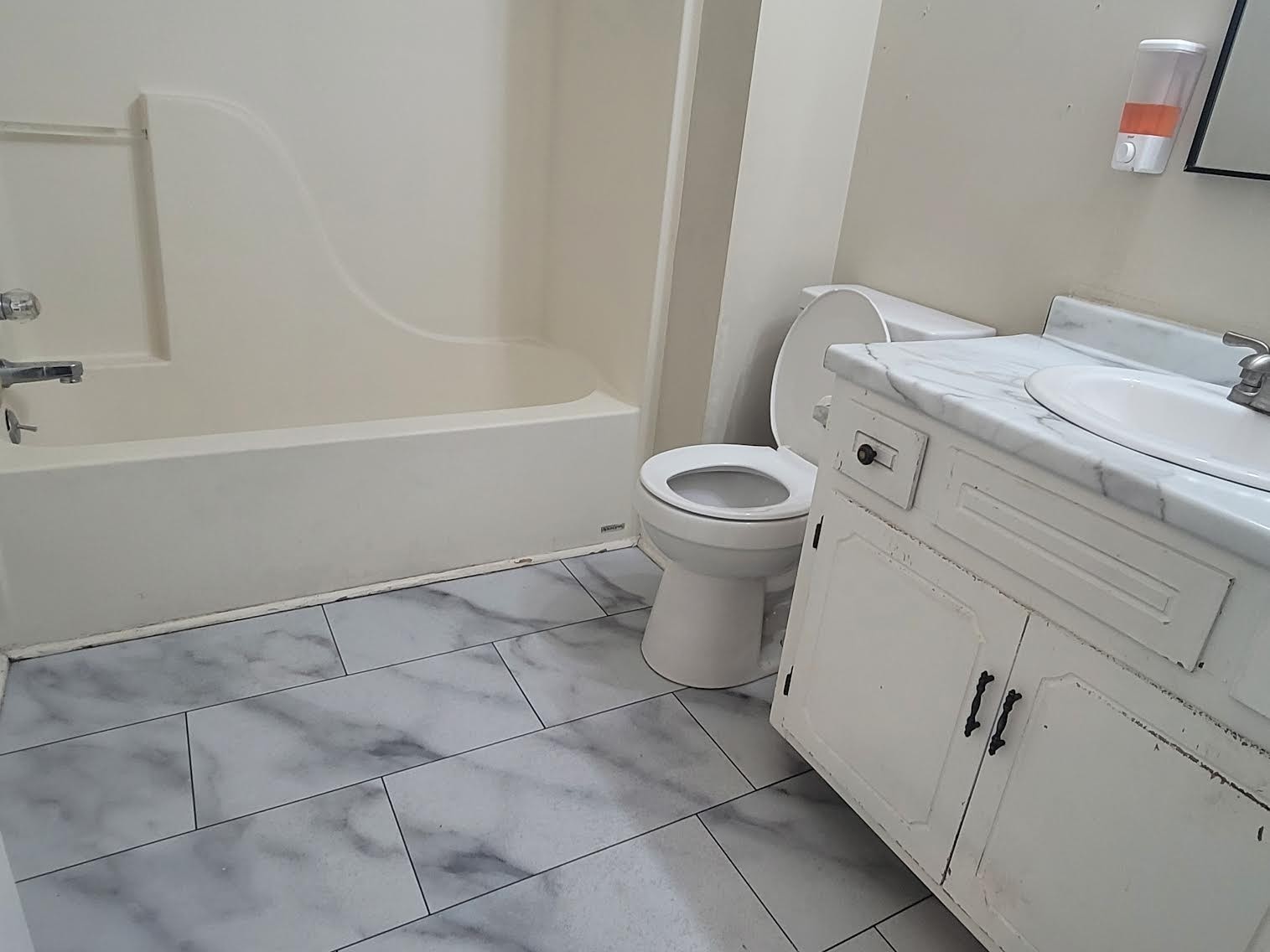 744 Needmore Road Clarksville, TN 37040 - Photo 10 of 12 a white toilet sitting next to a bath tub