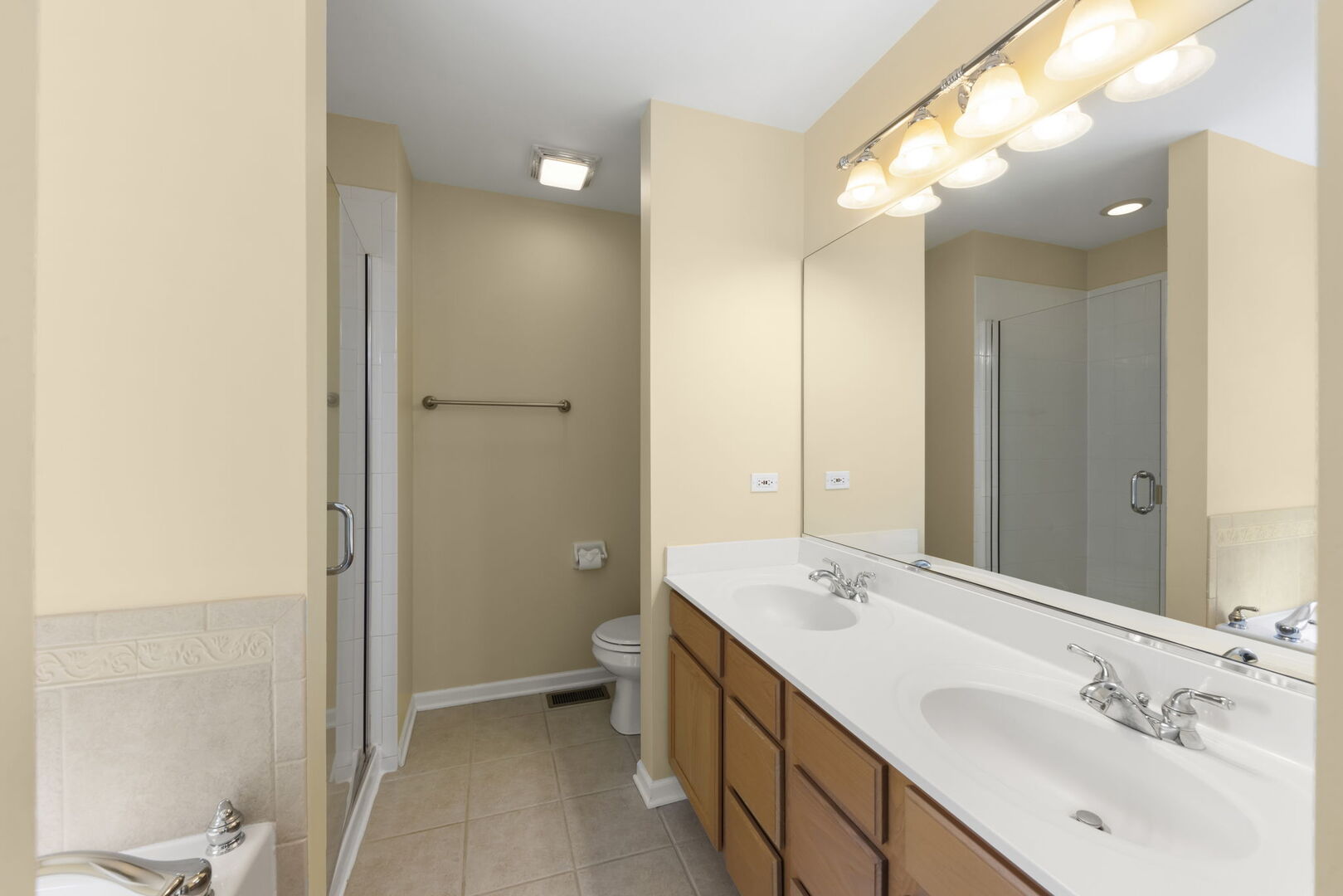 1728 Pershing Avenue, Unit 3 Wheaton, IL 60189 - Photo 16 of 32 a bathroom with a double vanity sink mirror and shower