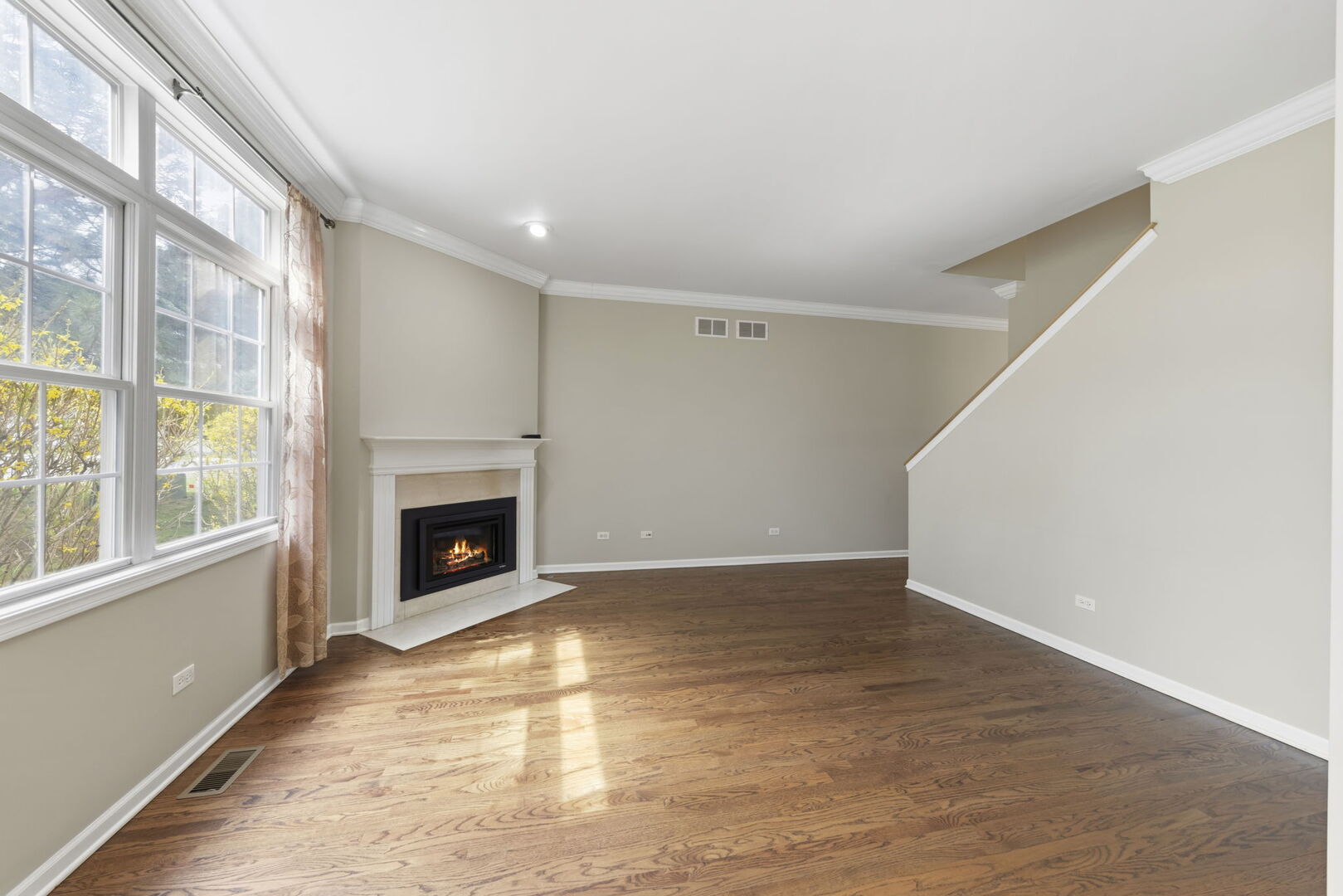 1728 Pershing Avenue, Unit 3 Wheaton, IL 60189 - Photo 6 of 32 a view of an empty room with a fireplace and a window