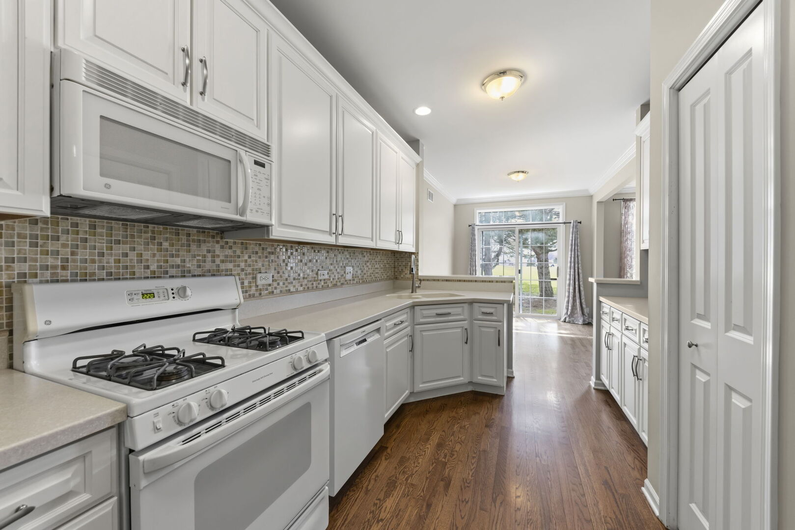 1728 Pershing Avenue, Unit 3 Wheaton, IL 60189 - Photo 8 of 32 a kitchen with granite countertop cabinets stainless steel appliances and wooden floor