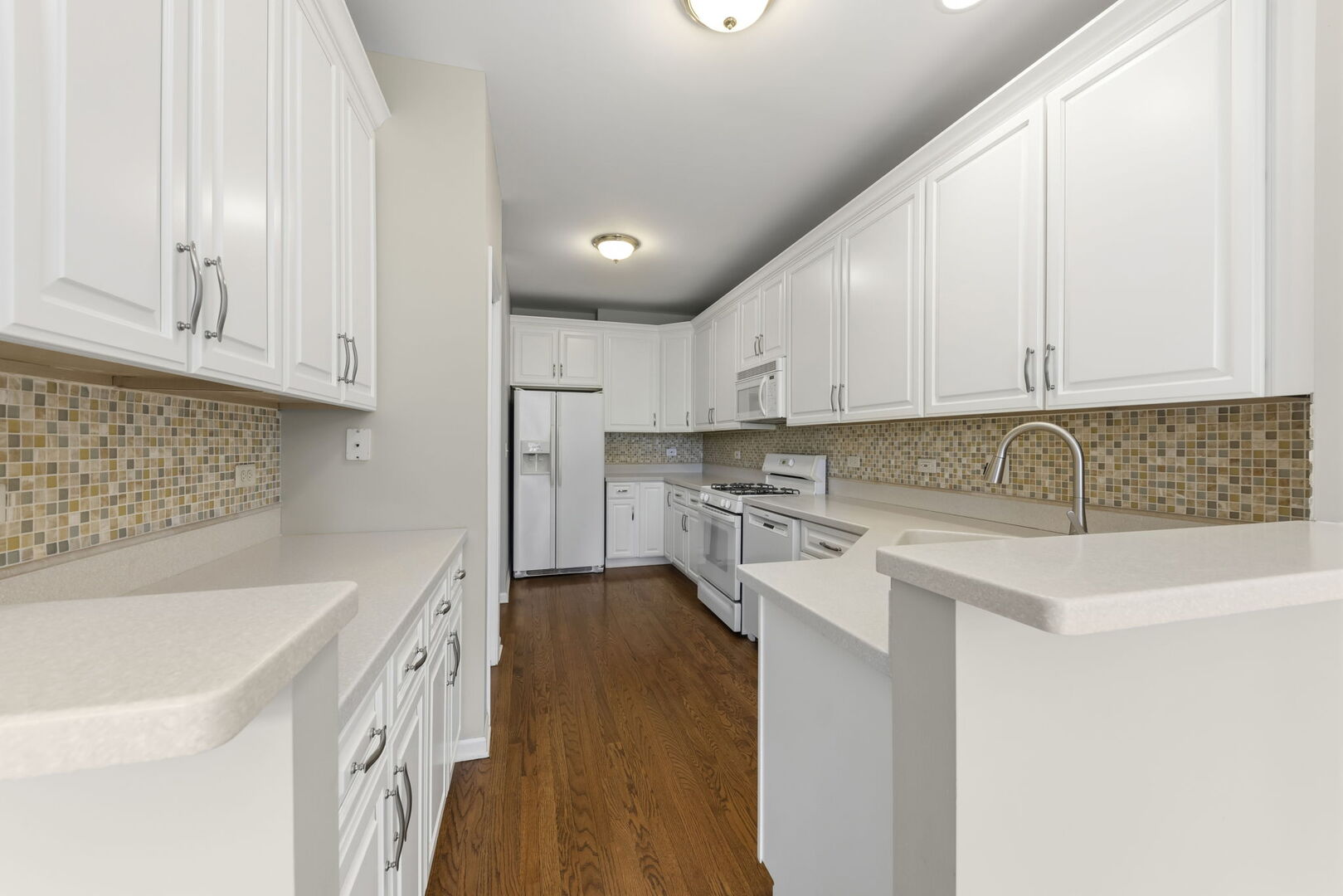 1728 Pershing Avenue, Unit 3 Wheaton, IL 60189 - Photo 9 of 32 a kitchen with stainless steel appliances granite countertop a sink and dishwasher a stove top oven with white cabinets