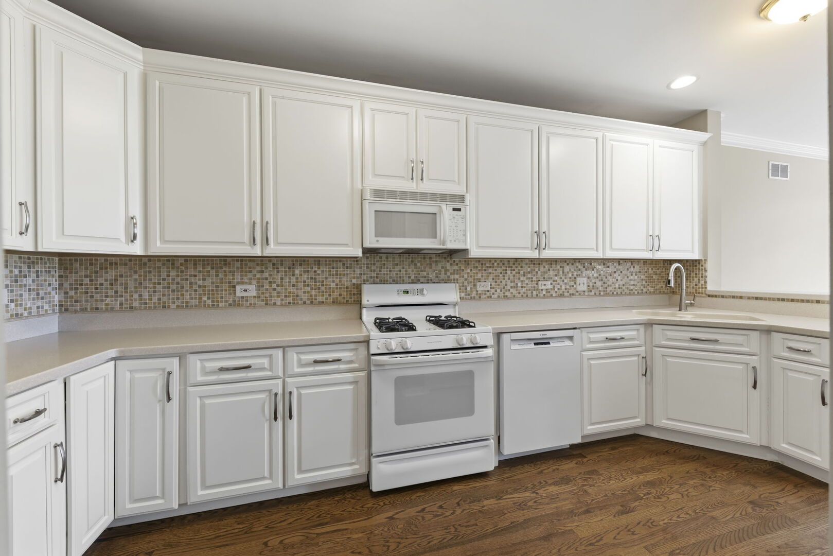 1728 Pershing Avenue, Unit 3 Wheaton, IL 60189 - Photo 10 of 32 a kitchen with white cabinets and sink