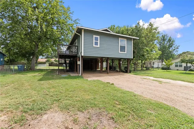 an aerial view of a city with lots of residential buildings ocean and mountain view in back