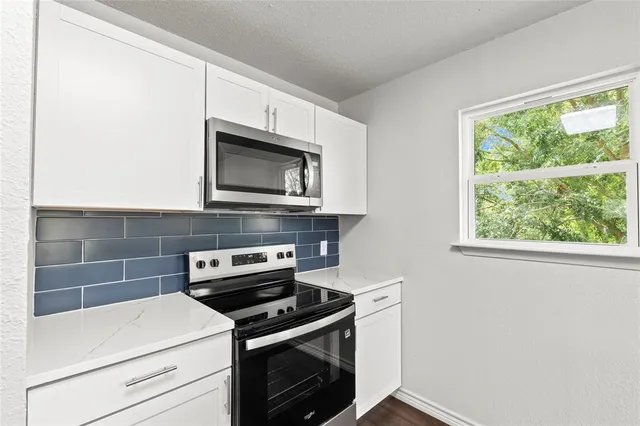 a view of a kitchen with wooden floor and a kitchen